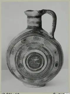 Pottery Bichrome IV jug with a globular body, strap handle and concentric circle decoration