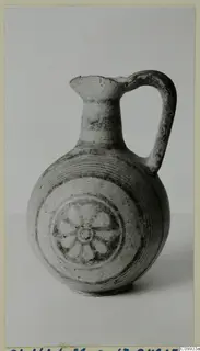 Bichrome V jug with a single handle and a rosette painted on its body