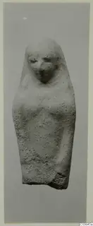 Stone statue of a standing figure with a veil or hood over the head, photographed against a grey background
