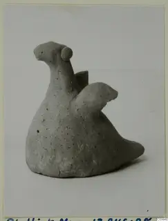 Terracotta figurine of an animal with a long neck, a knob-like head and a broken wing-like projection