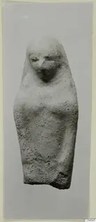 Terracotta figurine of a standing female figure with a covered head and arms close to the body.