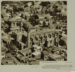 Aerial view of Ayia Sophia quarter, Nicosia, with a large stone building and minarets among dense rooftops