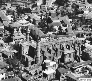 Aerial view of the Ayia Sophia quarter in Nicosia, with a large building with two slender minarets among dense rooftops