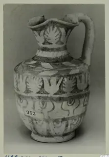 Painted pottery jug with a strap handle and bands of stylised plant motifs