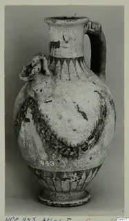 Painted pottery jug with a strap handle and a small applied lug on the shoulder