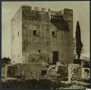 Kolossi castle, a square stone tower with a crenellated top, seen from the front