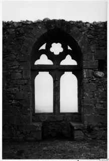 Ruined stone wall with an arched window opening with stone tracery, Vessberg, Kyrenia Mountains