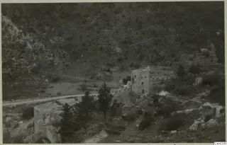 Ruined stone tower and walls among pine trees on a hillside in the Kyrenia Mountains