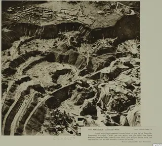 Aerial view of the Amiandos asbestos mine, with terraced open workings, dirt roads and buildings.