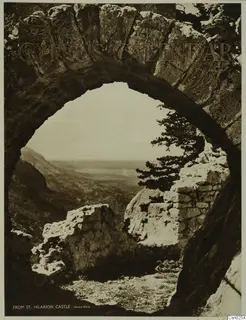 View through a stone arch over a hazy valley, with a tree and ruined walls, on a printed cover