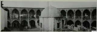 Courtyard of a building in Nicosia with arcaded galleries, a central dome and washing lines