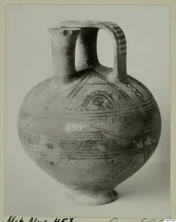 White Painted I jug with a spout, strap handle and ring base, decorated with painted bands and arched motifs