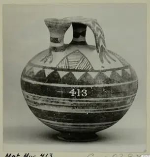 White Painted I jug with a strap handle, dark banded decoration and a row of triangles below the shoulder