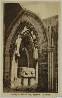 Printed postcard of a ruined pointed arch with stone tracery and a carved stone block beneath, Abbey of Bella-Paise, Kyrenia