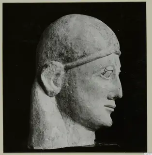 Limestone Neo-Cypriote head in right profile against a black background