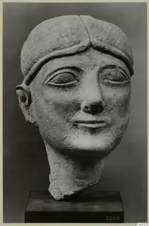 Limestone head of a figure, Neo-Cypriote, with a band across the forehead and a broken neck.