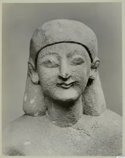 Limestone statue of a head and shoulders, Neo-Cypriote, photographed against a plain grey backdrop