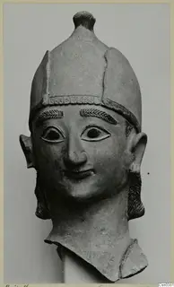 Terracotta head with a tall cap, incised eyebrows and a slight smile, seen from the front