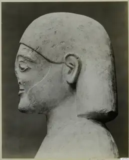 Limestone Proto-Cypriote statue head and shoulders, shown in profile facing left