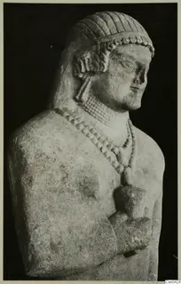 Limestone Cypro-Greek I statue, upper body, with banded hair, a beaded necklace and one hand held at the chest