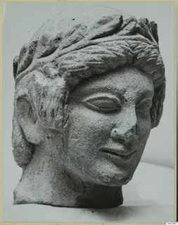 Limestone head with a leafy band in its hair, from Mersinaki, shown in three-quarter view