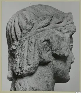 Limestone head in profile from Mersinaki, facing right, with grooved hair and a headdress