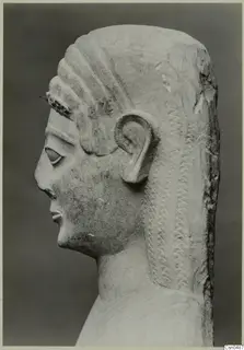 Limestone Neo-Cypriote bust in left profile, showing carved hair, ear and face against a dark grey backdrop