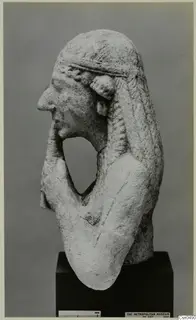 Limestone bust of a figure in profile with one hand raised to the chin.