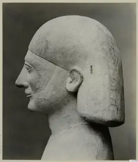 Limestone Cypro-Egyptian bust in profile, facing left, with a squared hair block falling behind the ear.