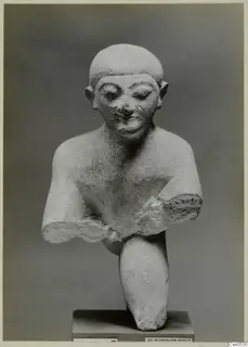 Limestone Cypro-Egyptian bust of a figure with a close-cut head and broken arms, set on a square base