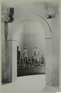 Statues and small figurines displayed on a curved plinth inside an arched recess, Cyprus Museum