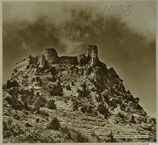 Kantara Castle, a ruined stone fortification on a rocky hilltop under a cloudy sky