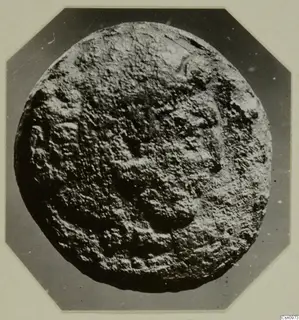 Round find from Kountoura Trachonia with a rough, encrusted surface and raised markings