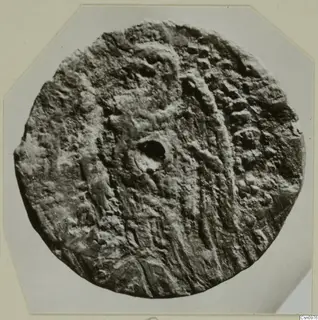 Round find from Kountoura Trachonia with a ridged, pitted surface and a central hole