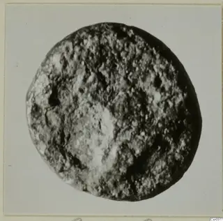 Find from Kountoura Trachonia: a round object with a pitted, granular surface, photographed close up