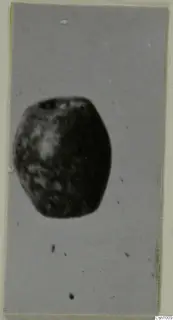 Small barrel-shaped stone object with holes at its top, from the Kastros tombs at Lapithos