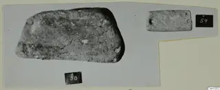 Two worked stone objects photographed on a card mount, numbered 58 and 59, from the Vrysi tou Barba tombs at Lapithos