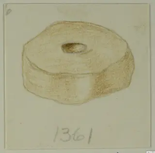 Drawing of a small disc-shaped object with a central hole, in brown crayon on card.