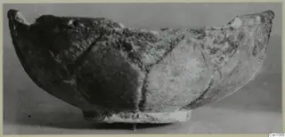 Shallow bowl on a low ring foot, rough surface with dark lines dividing its outer wall into panels, from Enkomi