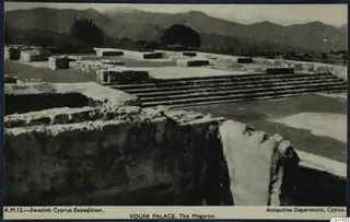 Ruined megaron at Vouni Palace with a flight of stone steps and mountains behind