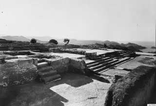 Stone steps and low walls at the palace at Vouni, with hills and sea beyond