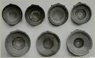 Seven shallow bowls with concentric ring patterns from Marion, seen from above on a light background.