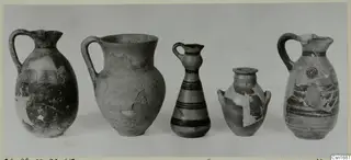 Five pottery vessels in a row, jugs and juglets with painted bands, from Marion