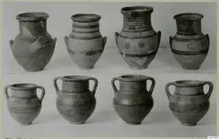 Two rows of painted pottery vessels from Marion, decorated with dark bands and concentric circles