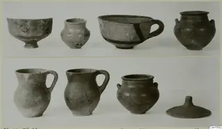 Group of vessels from Marion in two rows, including a cup-like bowl with a dark painted band, two jugs and a domed lid