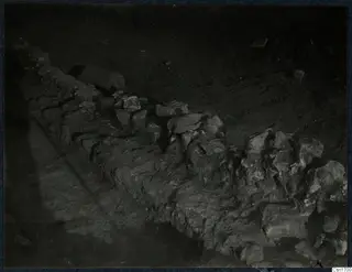 Excavated line of rough stones at Cholades, Soli, running diagonally across bare earth