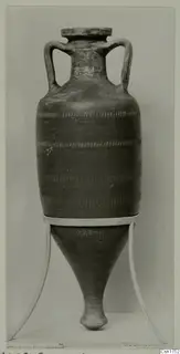 Two-handled jar with a tapering pointed base and bands of notched decoration, shown on a white stand