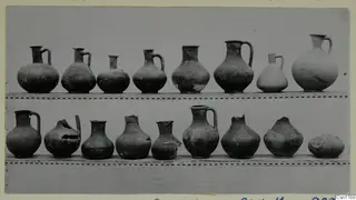 Two rows of pottery jugs and jars on shelves, from Ajii Omologitades, Politiko and Limassol Oasis