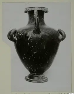 Black-glazed vessel with three handles and a grooved lower body.