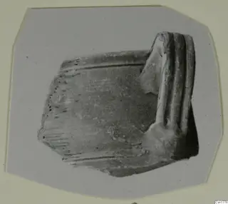 Part of a handle: a broken fragment with three raised ridges along one end
